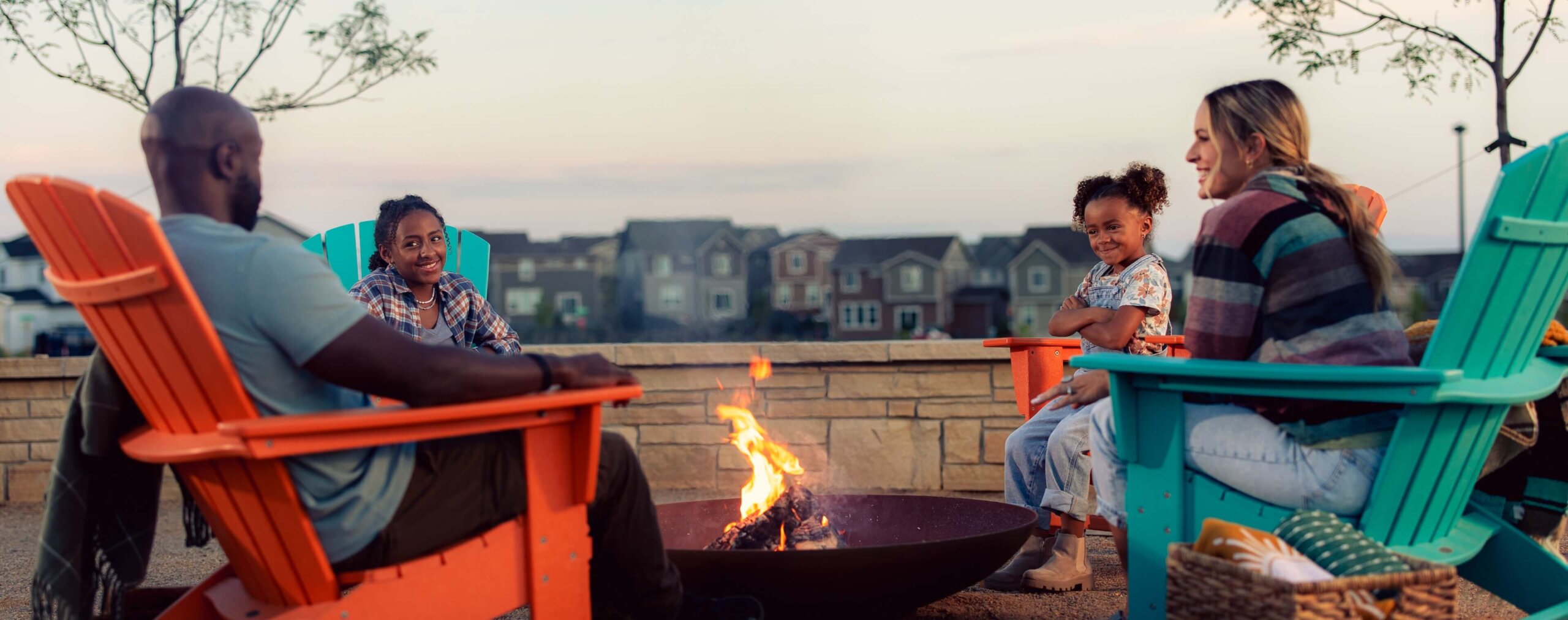 A family sits by a fire.